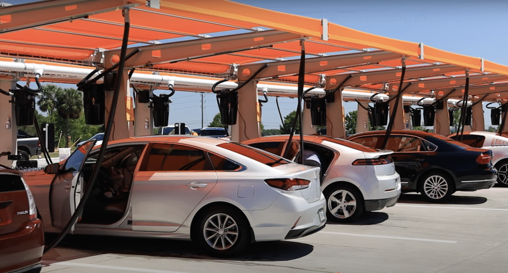 Modern self-service car wash in Groveland FL with multiple vehicles under shaded vacuum stations on a sunny day