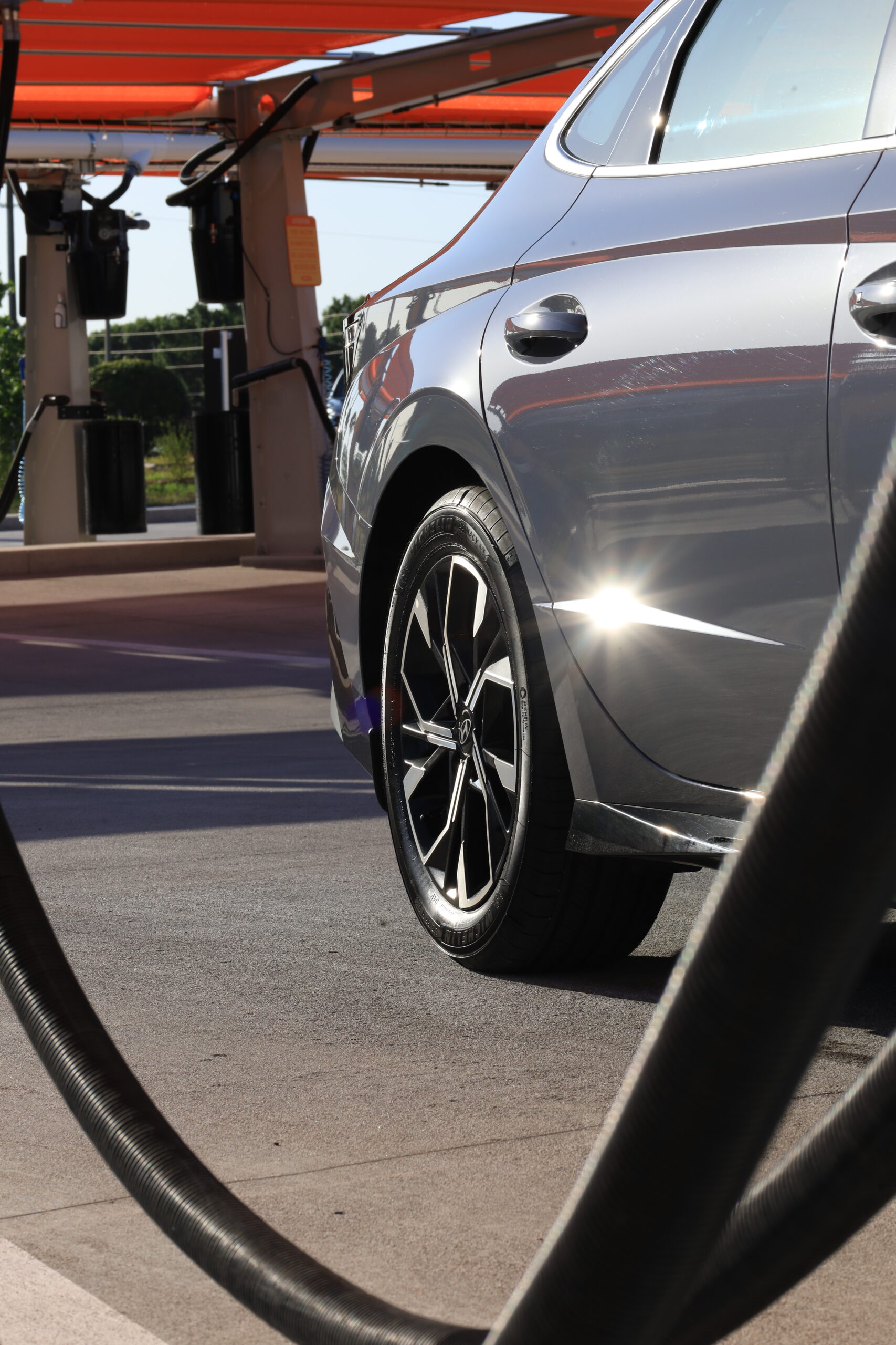a shiny and shimmering gray car after an express car wash session